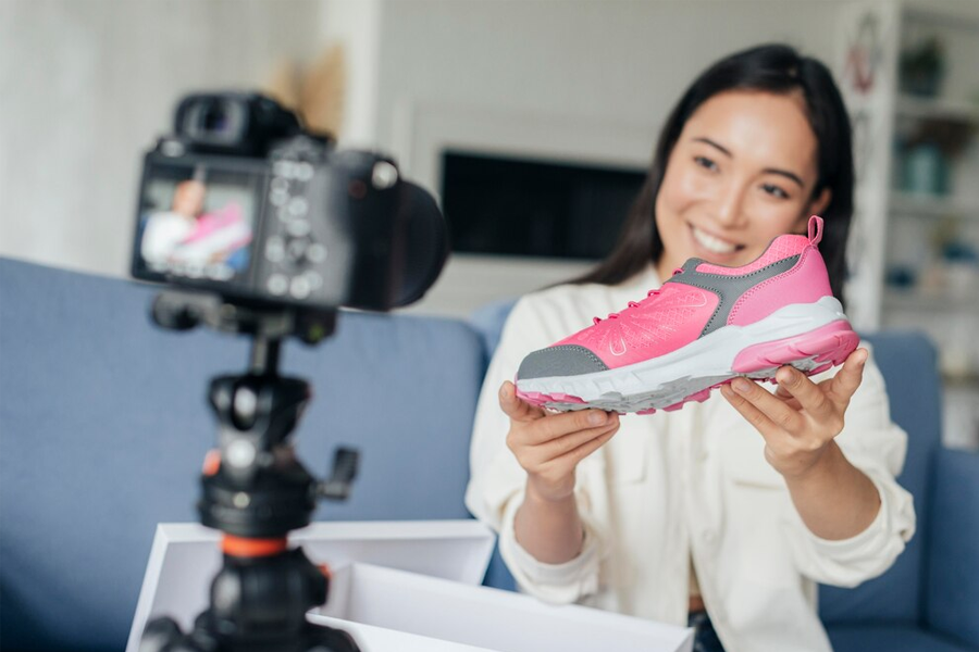 Woman shoots a video, promoting sneakers